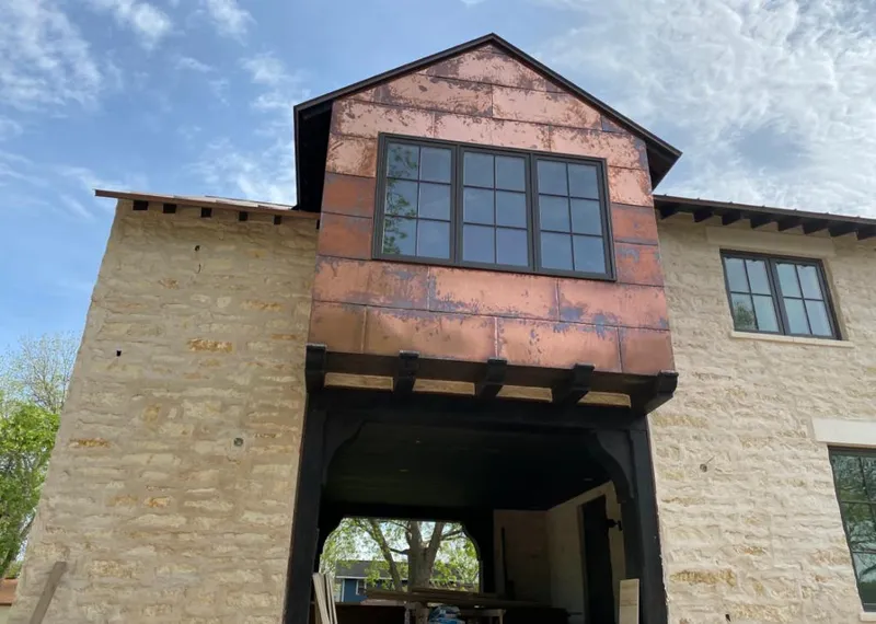 Copper metal panel facade on a stone building for Roof Repair in Guadalupe